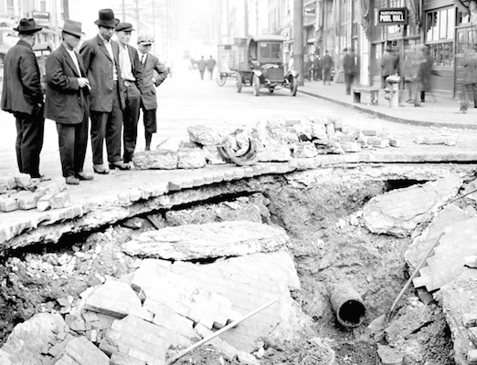 People standing around broken water main in 1918 Seattle 